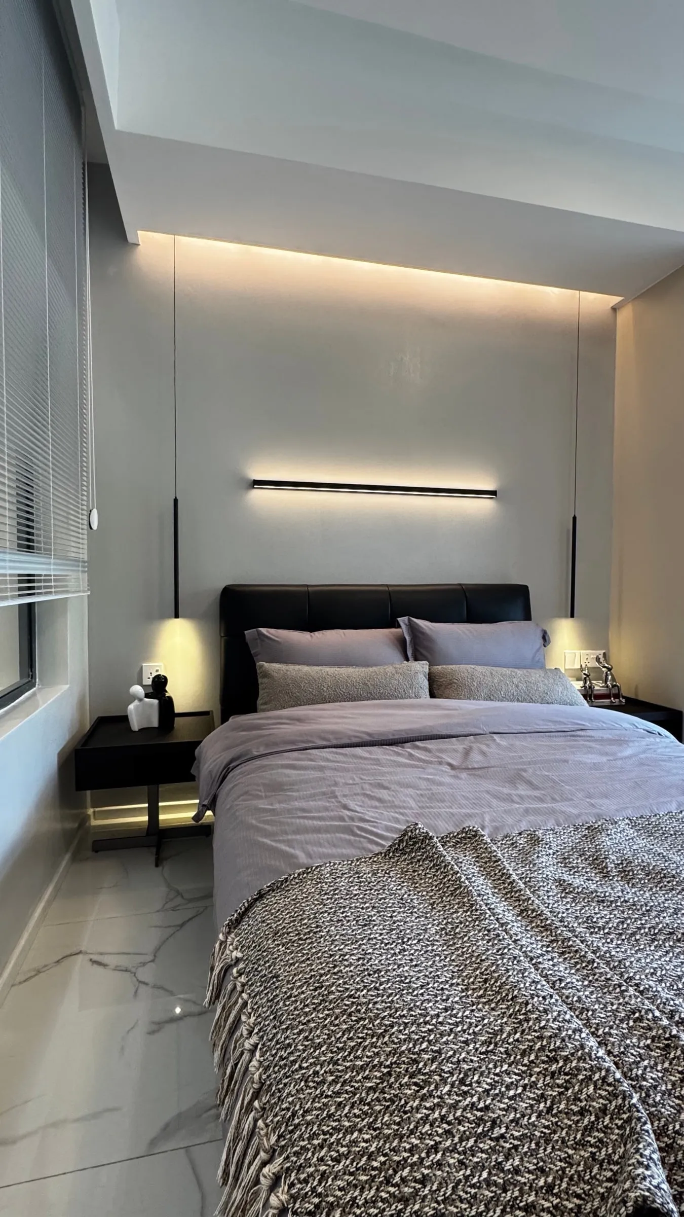 Bedroom with a padded headboard, wall lights and a built-in wardrobe