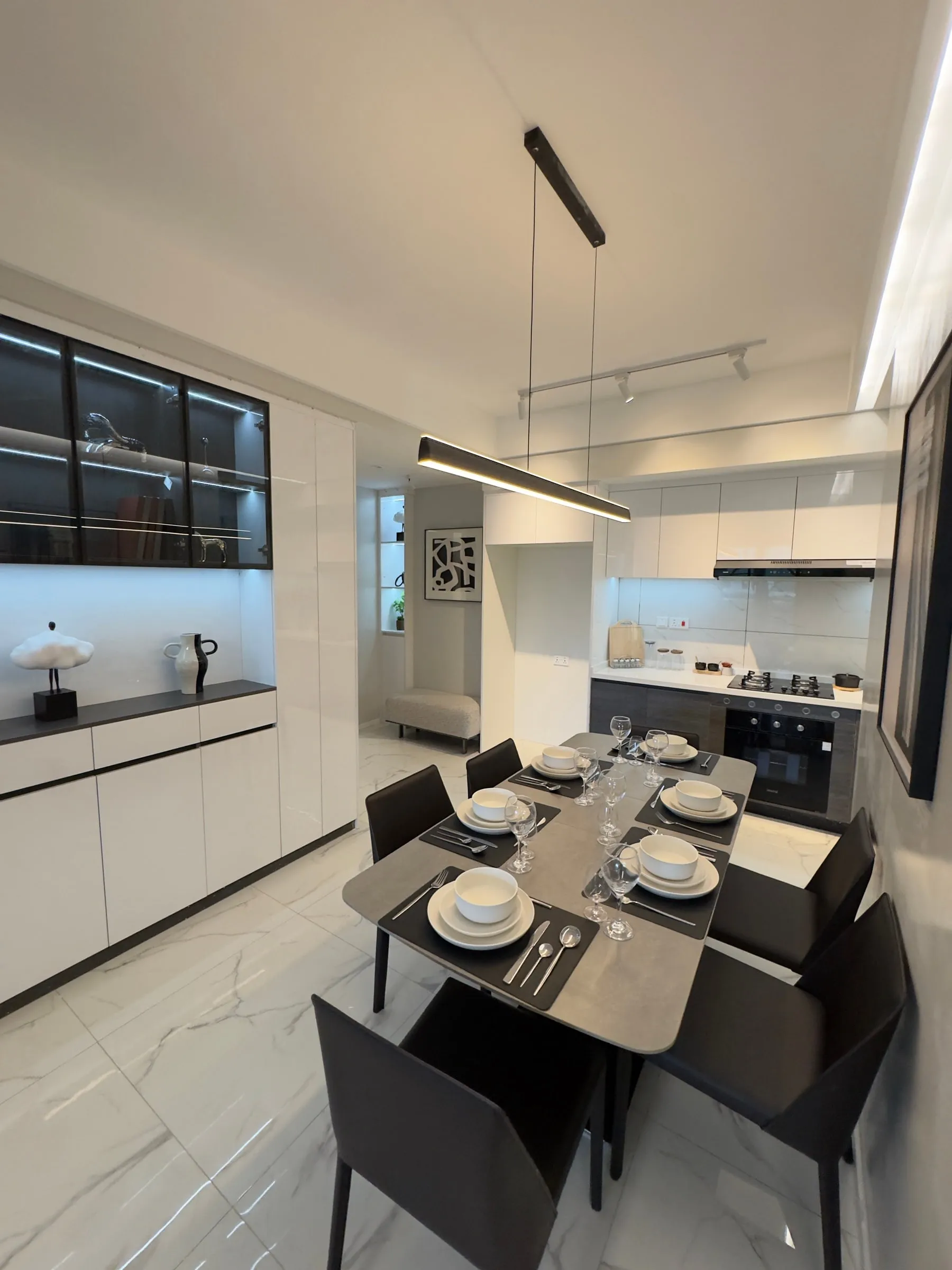 Dining table set for six in front of the open kitchen