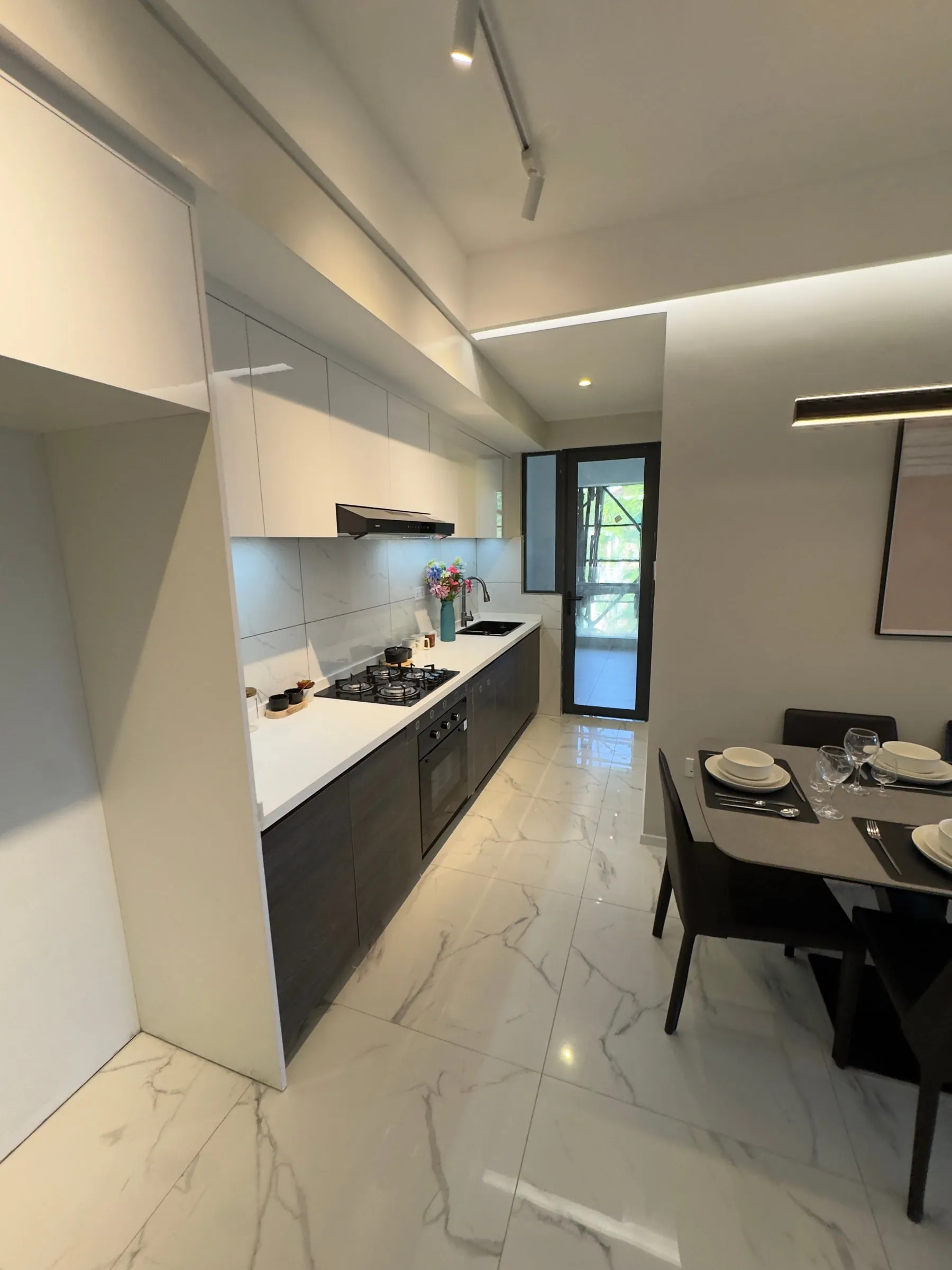 Galley kitchen leading to the dining area and a window