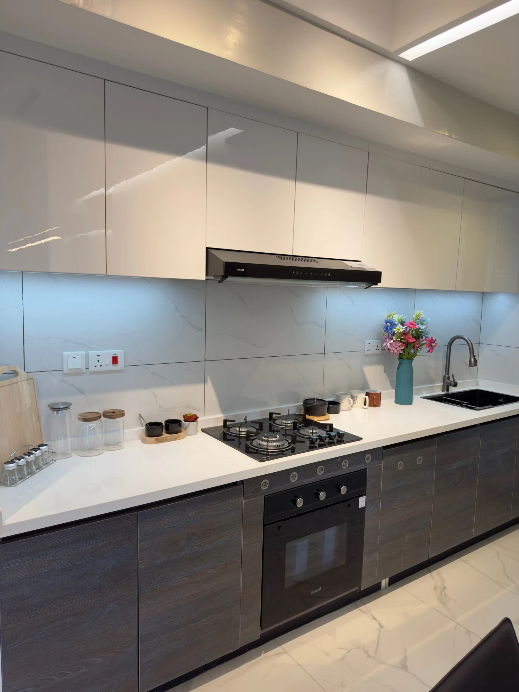 Kitchen with white upper cabinets, a gas hob and a built-in oven