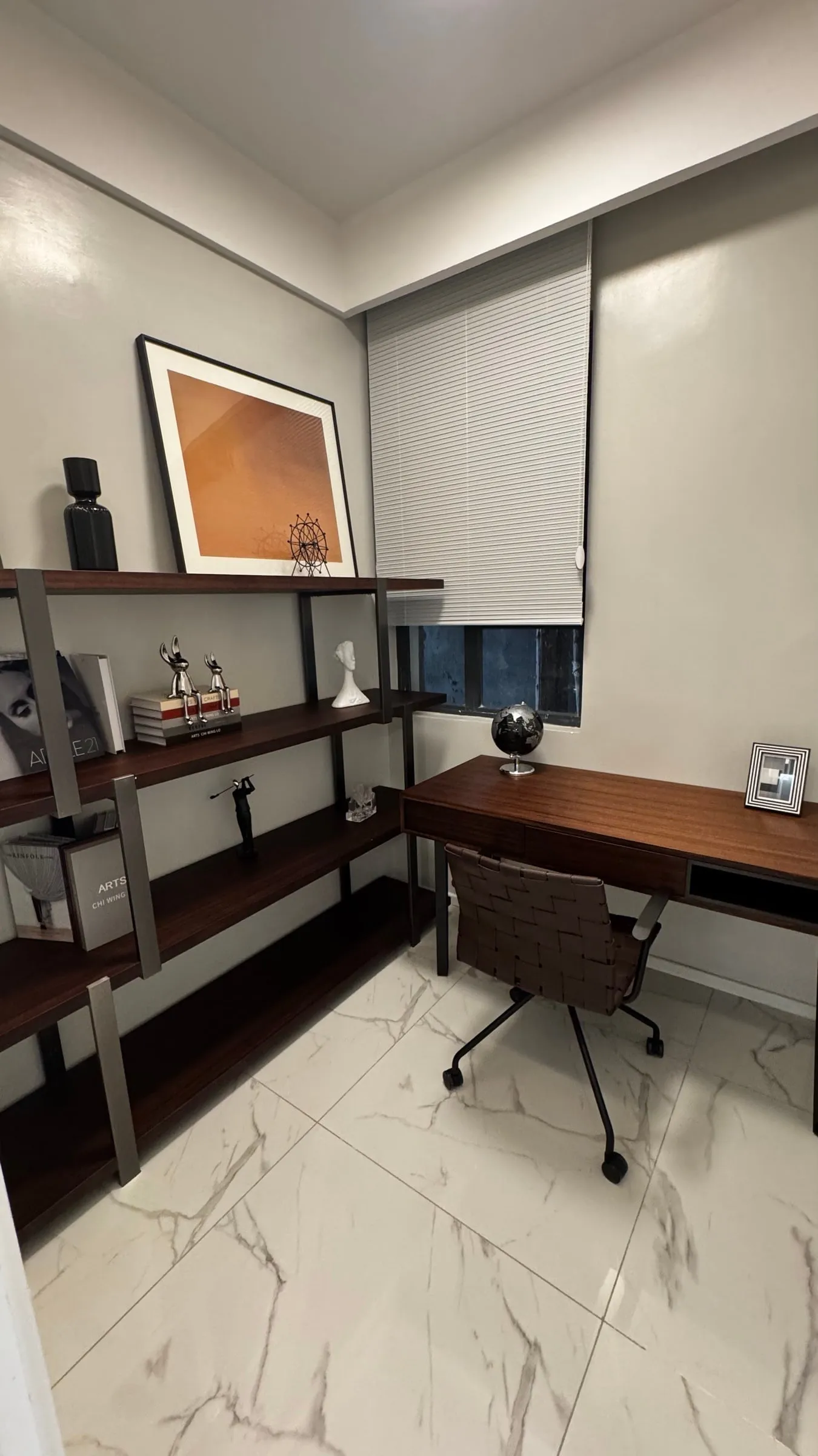 Study with a wooden desk, office chair and open shelving